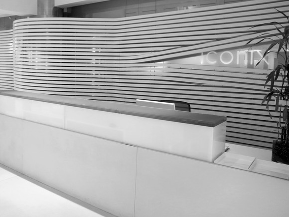 A lobby at Iconix headquarters. The office furniture, walls, and floor are all in glossy white.