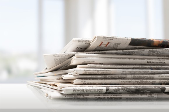 A pile of newspapers on a table