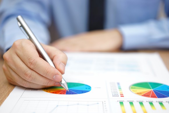A businessman working on a company's charts.
