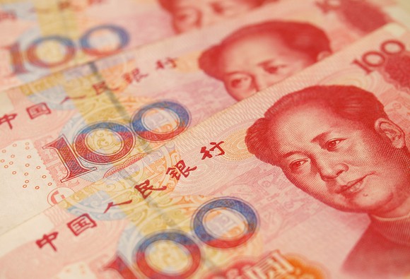Close up of 100 RMB yuan bills fanned out.