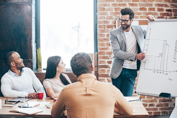 Man presenting data to colleagues