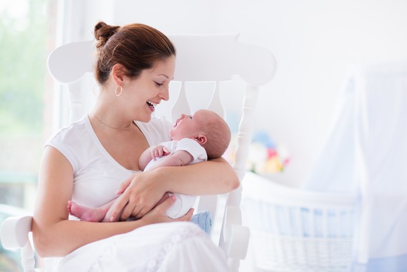 Woman holding a baby in a rocking chair