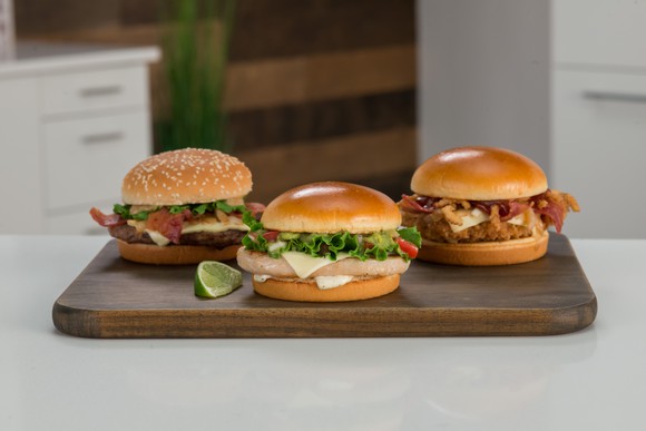 The three new signature artisan sandwiches at McDonald's on a cutting board.