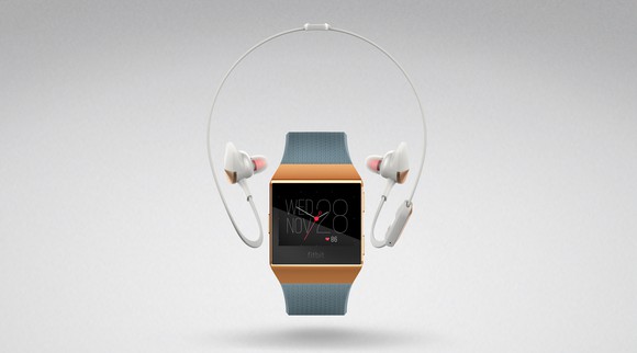 Fitbit Ionic smartwatch with earbuds above it.