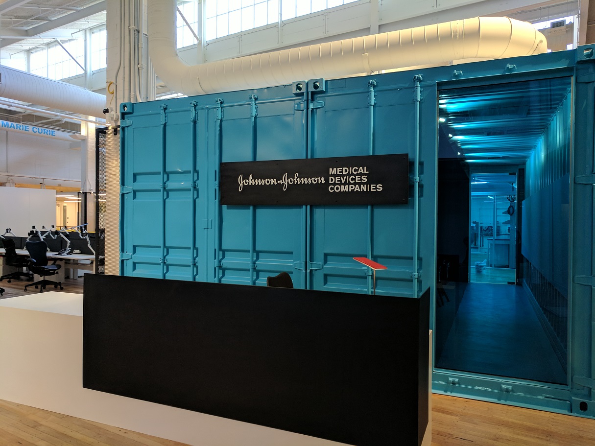 Reception area for medical device development laboratory contained within a larger warehouse-style building facility.