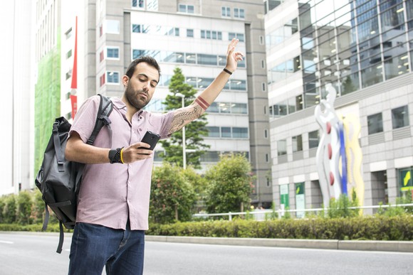 Man using smartphone for ridehailing
