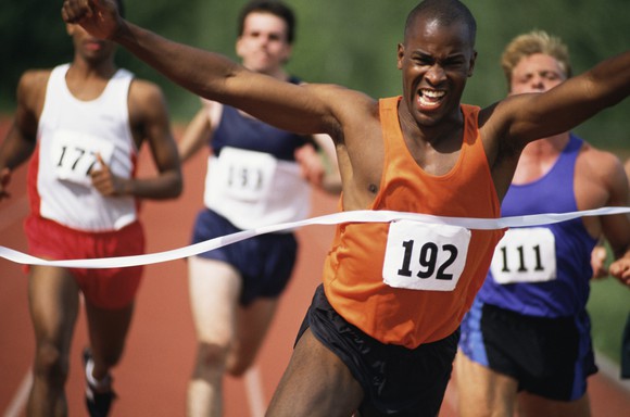 racer crossing finish line in victory