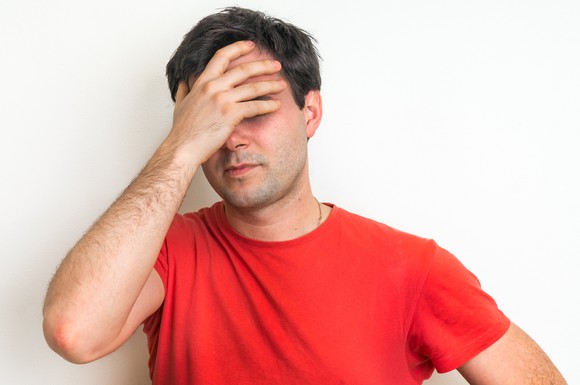 Man covering his face