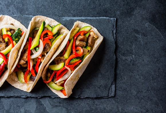 Tacos sitting on a table.