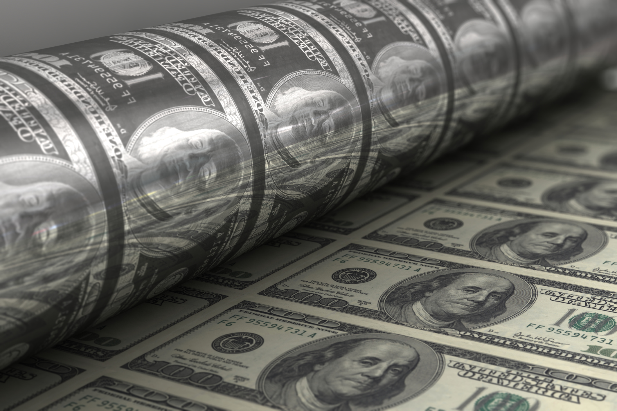 A machine printing hundred dollar bills.