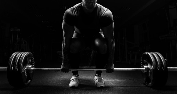 A man lifting a bar with weights on it