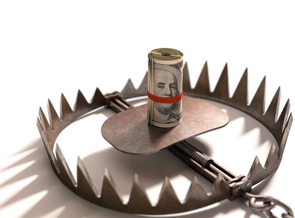 roll of hundred dollar bills in middle of bear trap