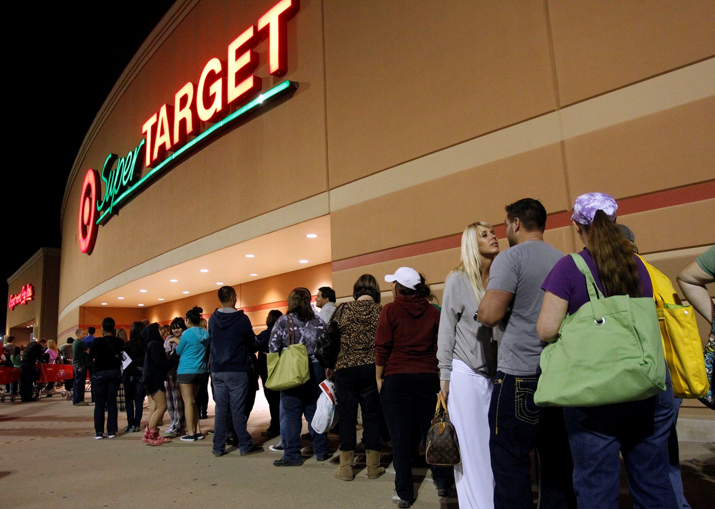 Customers line up for Black Friday outside of a Target store.