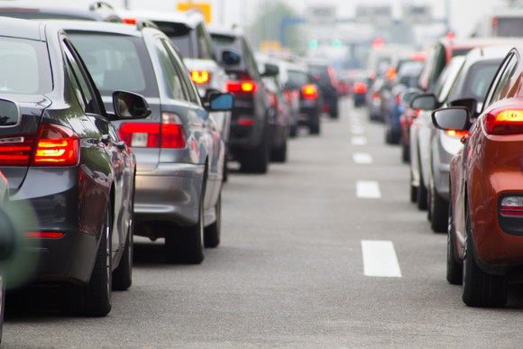 A highway is shown full of cars.