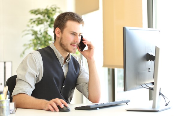 Professionally dressed man talking on the phone