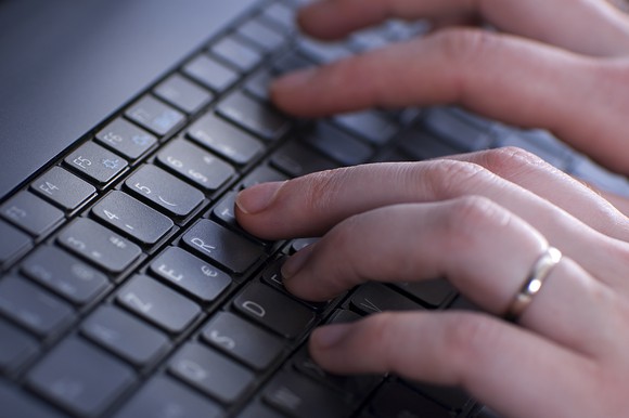 Hand typing on keyboard
