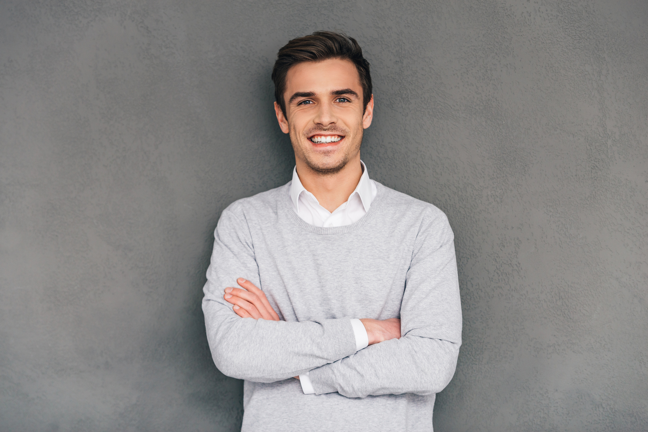 Smiling man against a gray background