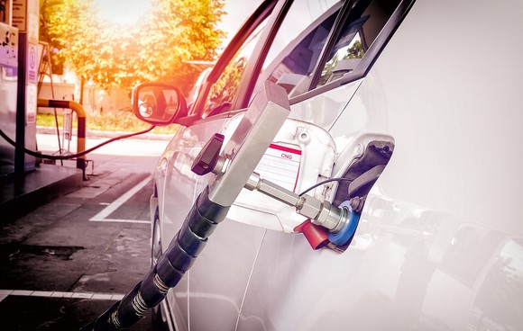 Natural gas car being filled with fuel.