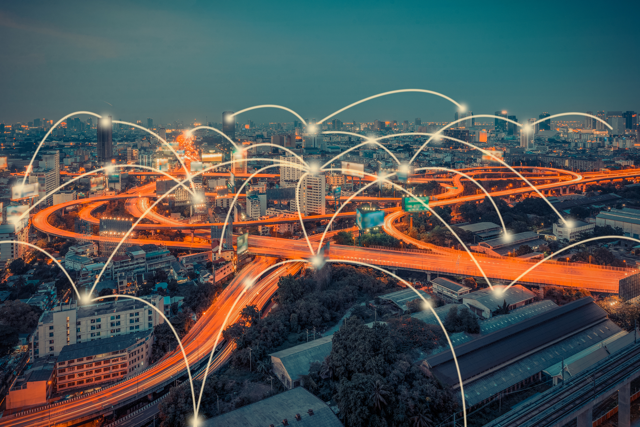 Cityscape with connected nodes indicating wireless communication.
