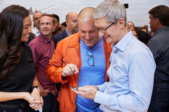 Apple CEO Tim Cook (right), Apple Chief Design Officer Jony Ive (center), and an unidentified woman (left).