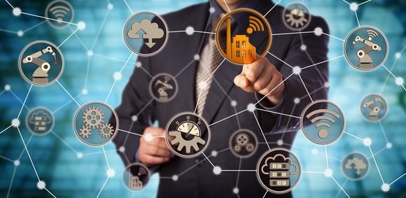 A man touching a smart factory icon in a virtual machine-to-machine network.