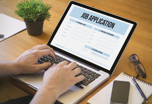 Person filling out online job application.