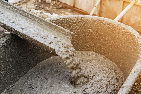 Cement mixer pouring into wheel barrel