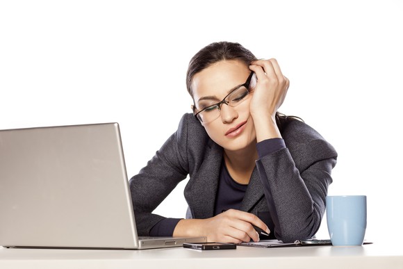 Professional woman falling asleep at her desk