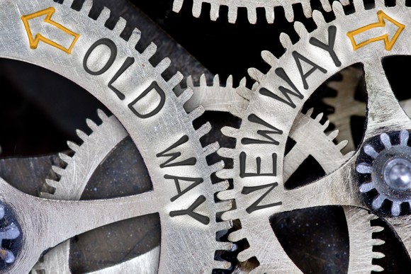 Gears with old way and new way printed on them