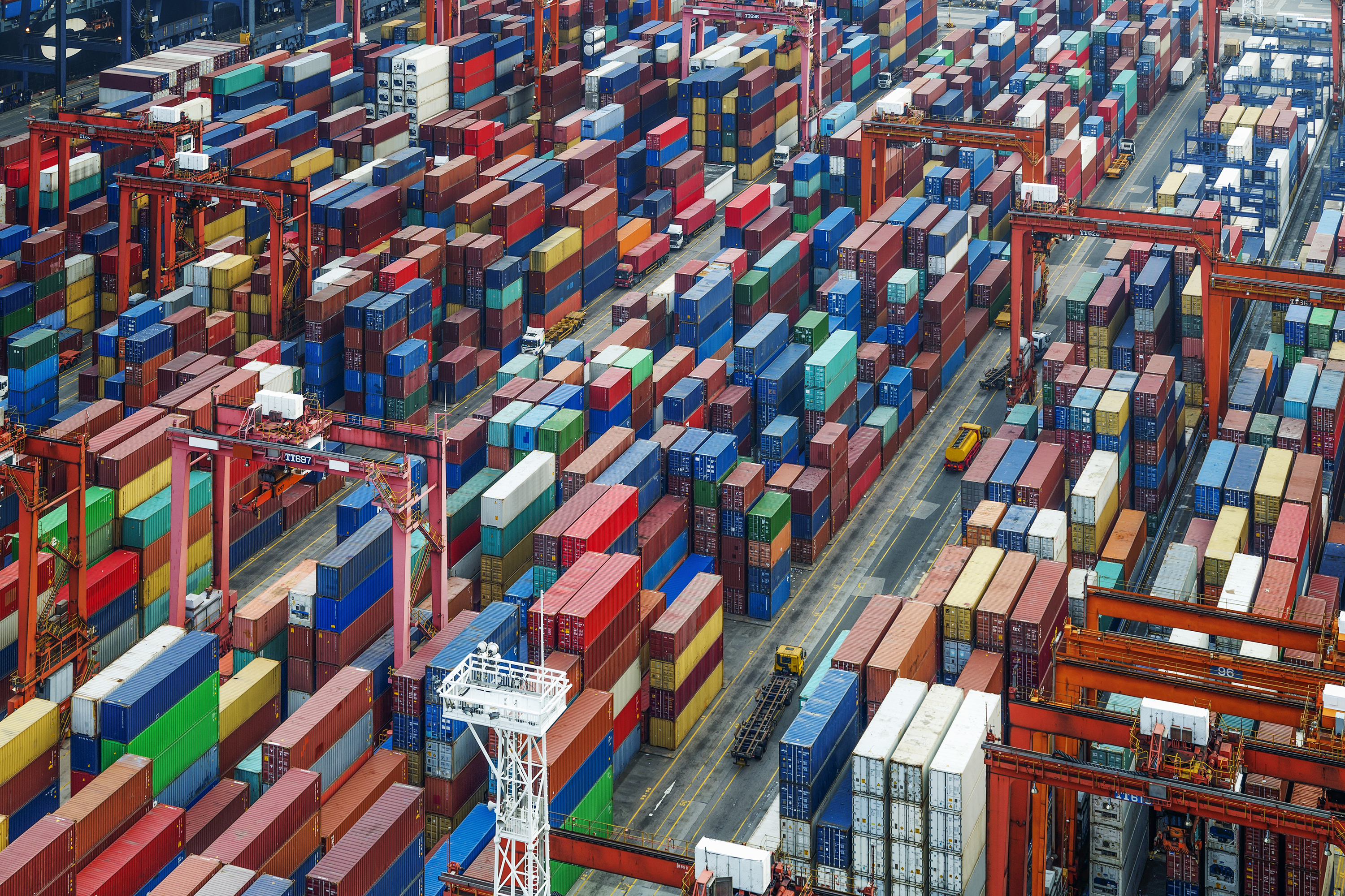 An overhead view of containers lined up at a port.