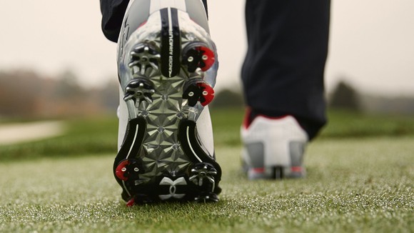 The underside of a golf cleat. 