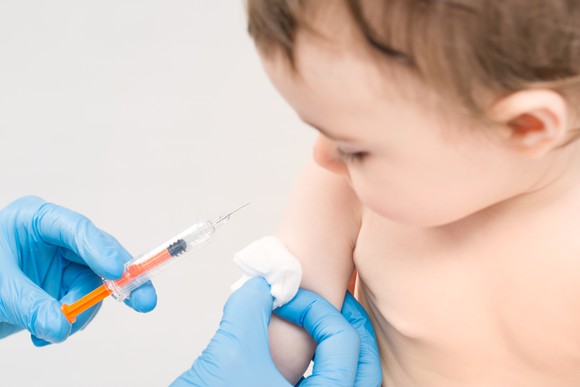 A baby is getting a shot.