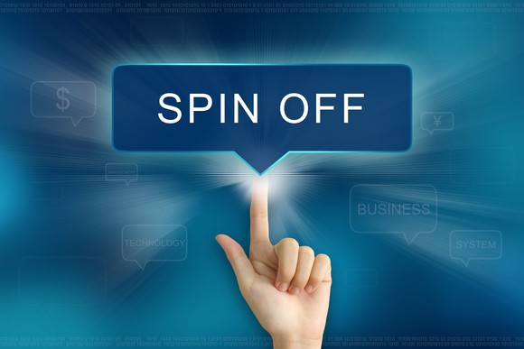 Finger tapping a sight that says Spin Off with light shining behind it.