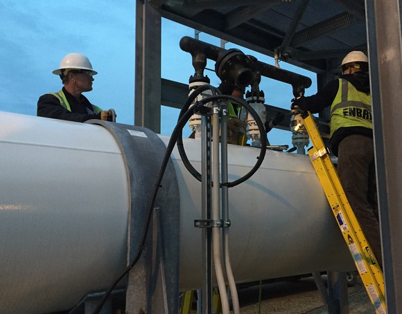 Enbridge workers testing a pipe.