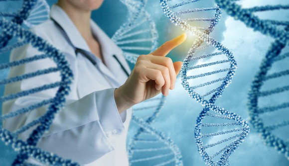 A person in a white lab coat pointing at a double helix.