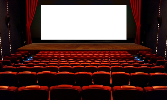 Empty movie theater with a white screen.