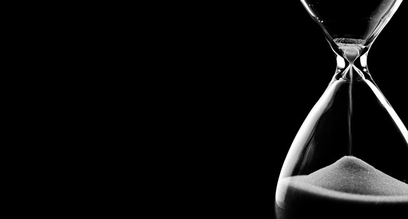 Sand running through the bulbs of an hourglass.