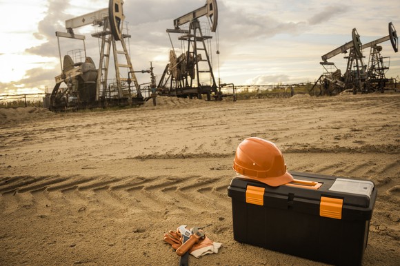 A tool box near some oil pumps.