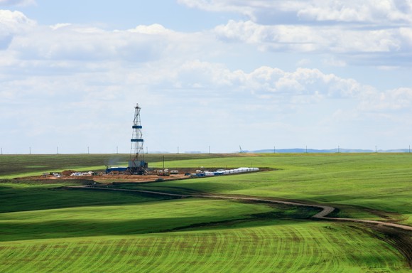 Drilling rig among agricultural fields.