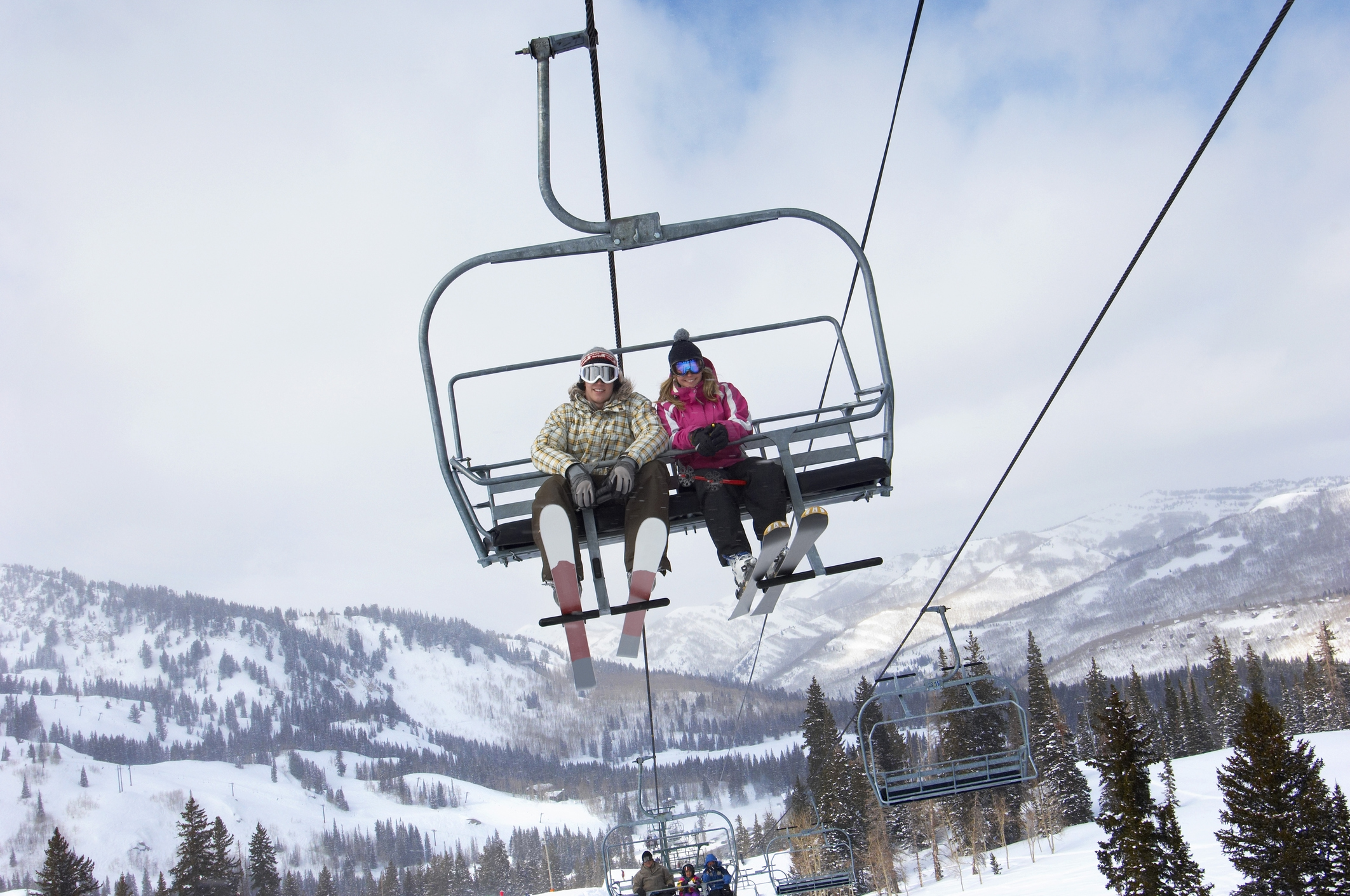 A couple riding a ski lift
