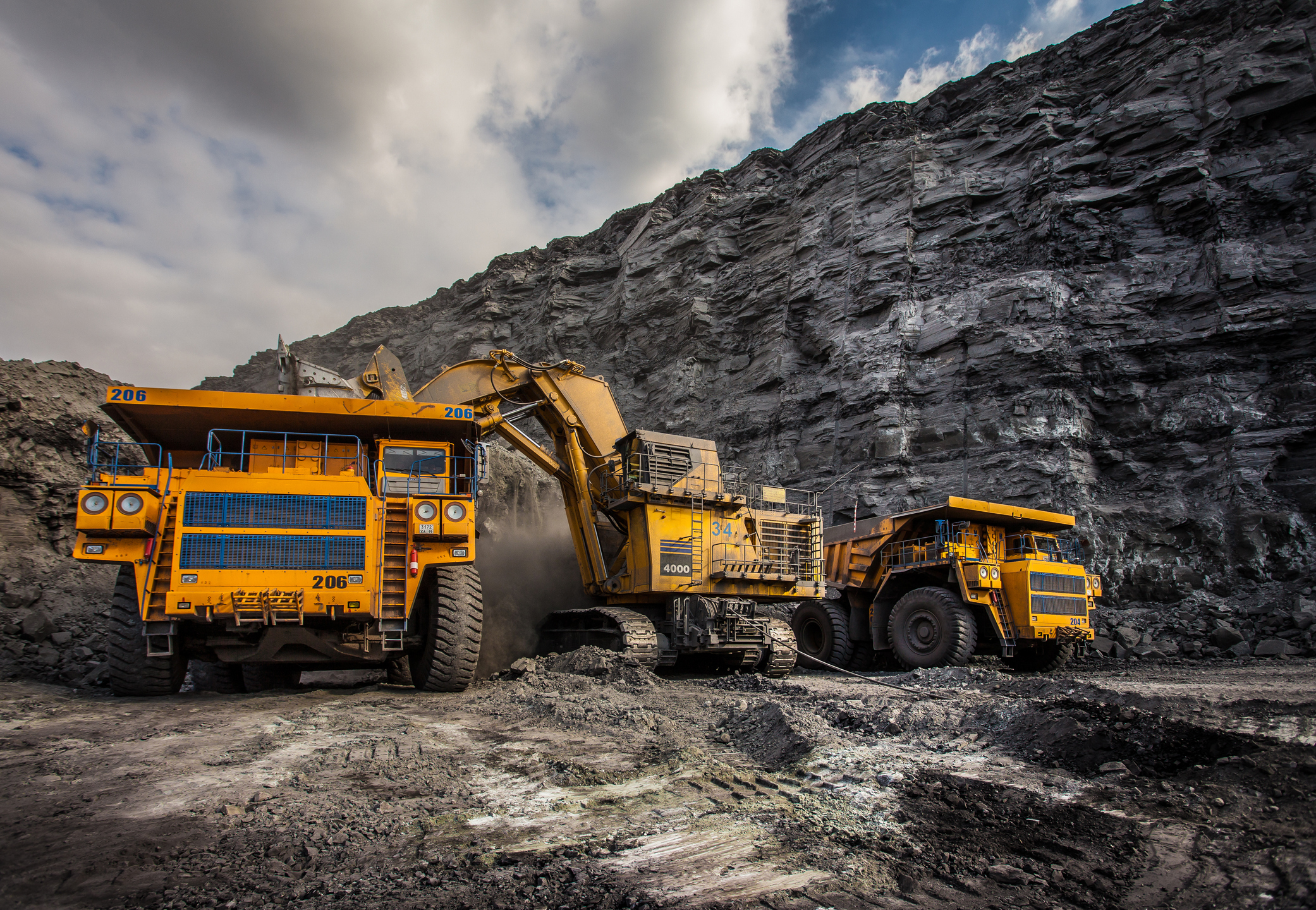 Several mining trucks operating at a site.
