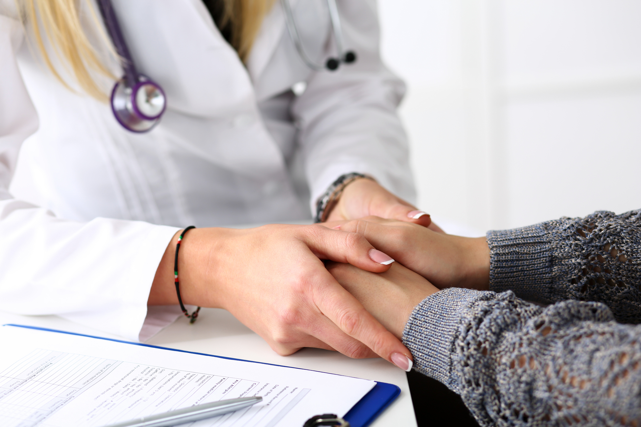 Doctor holding the hands of a patient.