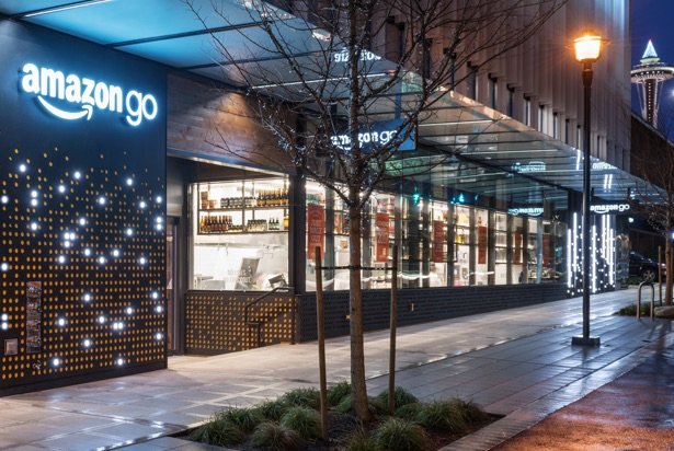 The exterior of the Amazon Go store at dusk with the Seattle Space Needle in the background.