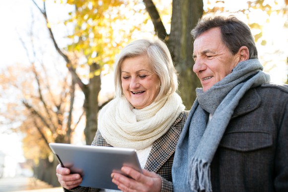 Senior couple looking at a tablet