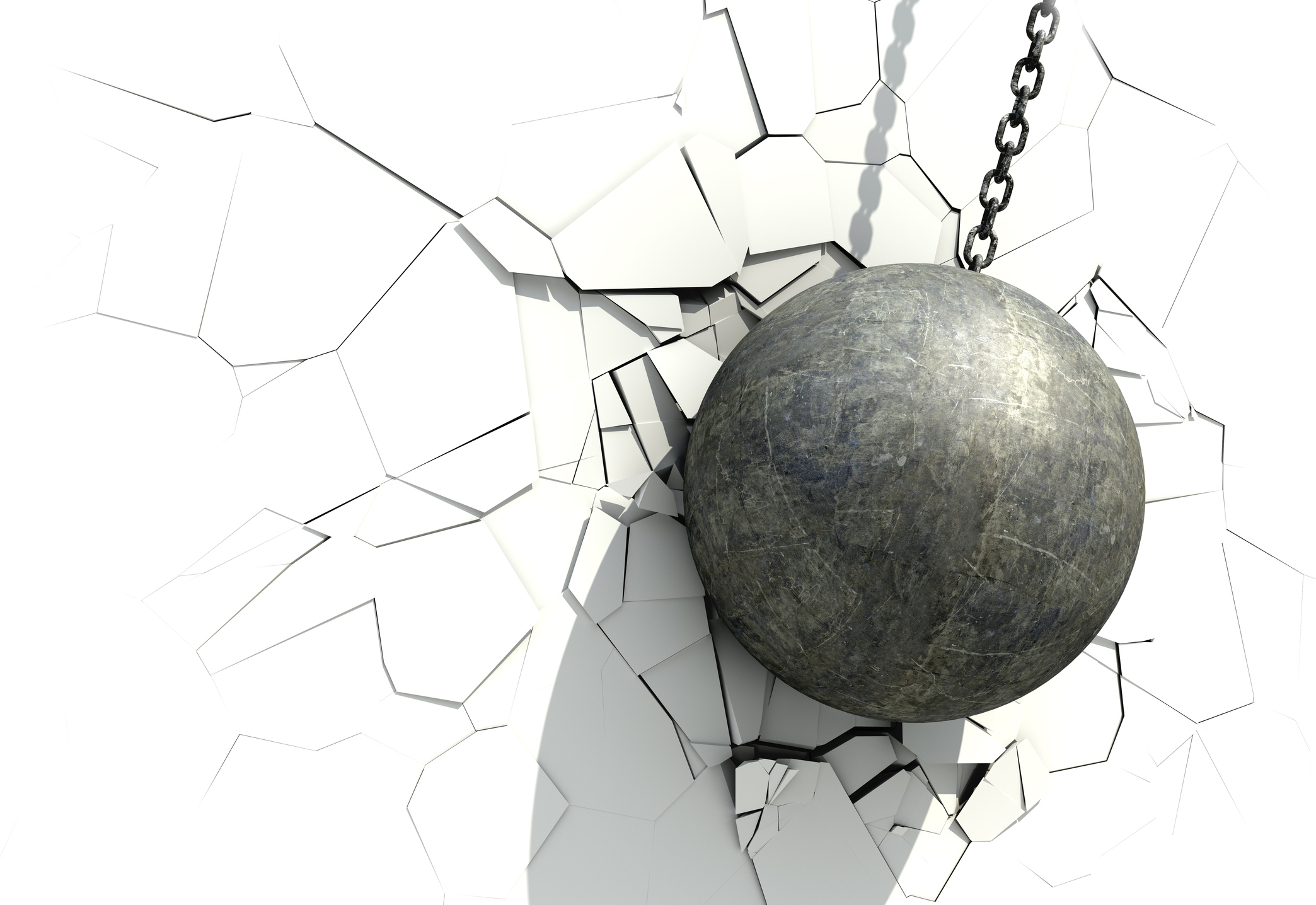 A metallic ball wrecking a white wall