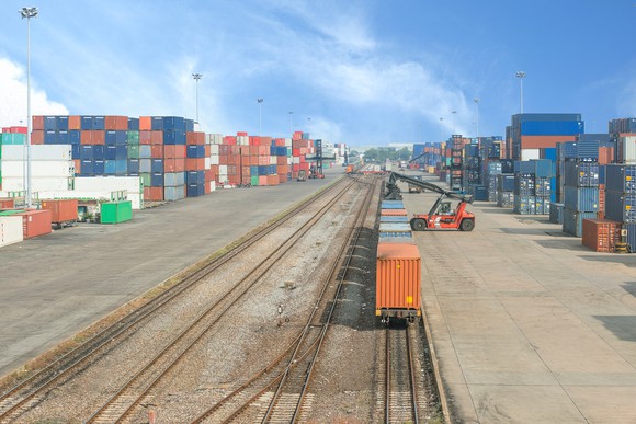 Loading intermodal rail cars at a terminal.