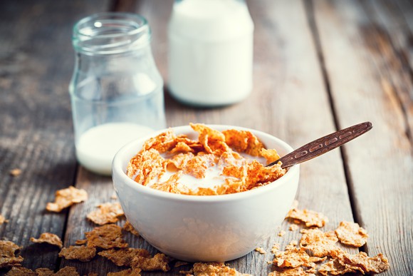 Cereal in a bowl on a wood table.