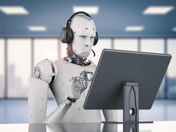 Robot types on a computer.