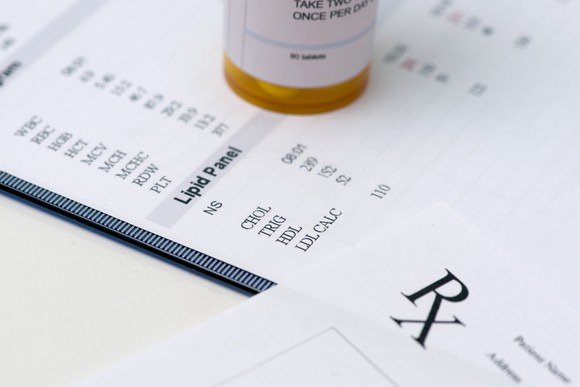 Lab results with a perception pad and a bottle of medicine