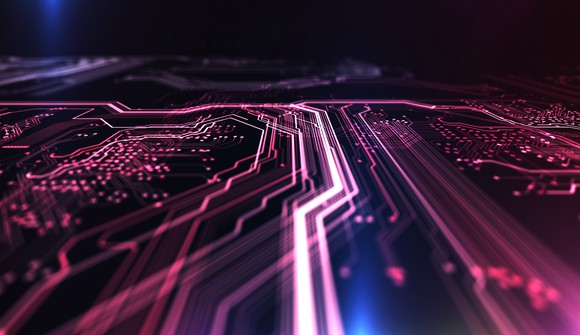 Computer circuit board illuminated in red and blue.